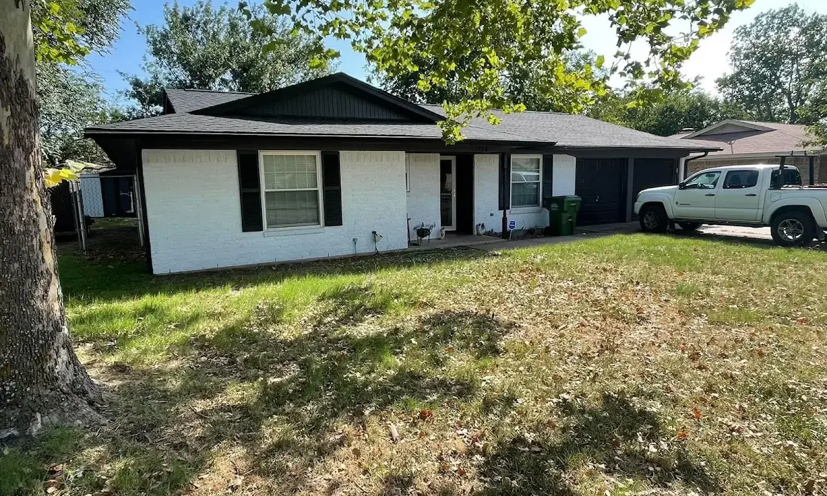 Professional roofing crew working on a residential roof in Bondurant